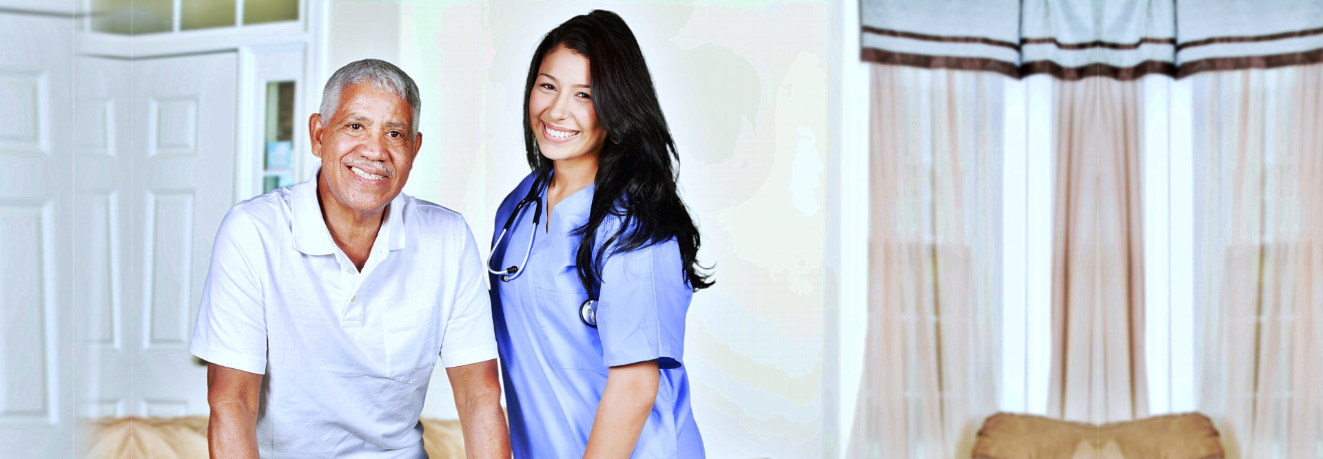 caregiver and elderly standing and smiling