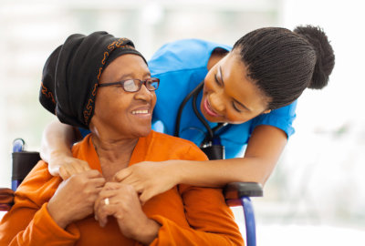 caregiver hugging the elderly woman