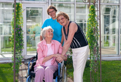 two elderly woman and a caregiver